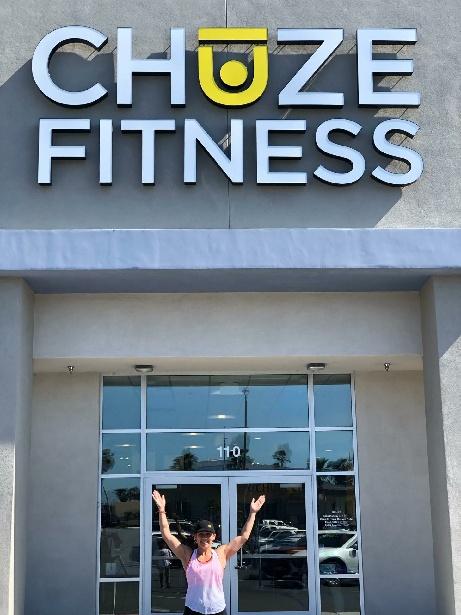 Group Exercise Instructor, Blanca Ramirez, in front of the entrance doors at Chuze Fitness