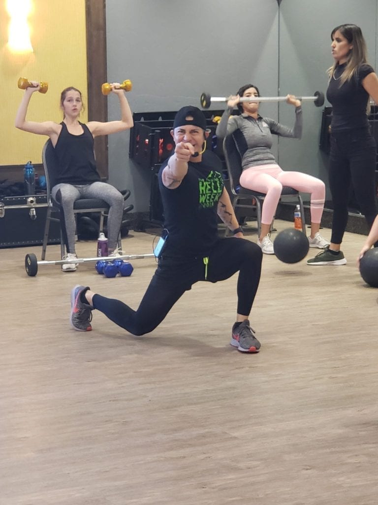 Instructor Chuy Vega pointing to camera in Bunz N Belly class at Chuze Fitness
